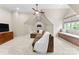 A spacious bonus room includes carpet, a sofa, a ceiling fan, and natural light at 132 Tuskarora Point Ln, Mooresville, NC 28117