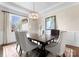 Formal dining room showcasing a beautiful chandelier and a large window for natural light at 132 Tuskarora Point Ln, Mooresville, NC 28117