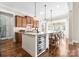 Stylish kitchen featuring an island with seating, wine cooler, and ample cabinet space at 132 Tuskarora Point Ln, Mooresville, NC 28117