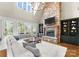 Inviting living room boasting a stone fireplace, built-in shelves, and lots of natural light at 132 Tuskarora Point Ln, Mooresville, NC 28117