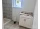 Bathroom with tiled walls, window and new vanity at 13308 Chopin Ridge Rd, Huntersville, NC 28078
