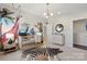 Adorable Bedroom with a patterned rug, a crib, a decorative wall mural, and a side table at 13308 Chopin Ridge Rd, Huntersville, NC 28078