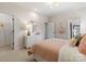 Comfortable bedroom features carpet, bed with decorative pillows and a large window at 13308 Chopin Ridge Rd, Huntersville, NC 28078