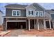 Striking two-story home with stone accents, a welcoming porch, and an attached two-car garage at 13308 Chopin Ridge Rd, Huntersville, NC 28078