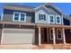 Beautiful two-story home with stone accents, covered porch, and attached two car garage at 13308 Chopin Ridge Rd, Huntersville, NC 28078