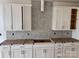 Bright kitchen featuring white cabinets with modern hardware and patterned tile backsplash at 13308 Chopin Ridge Rd, Huntersville, NC 28078