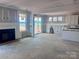 Bright living room with fireplace, large windows, and sliding glass doors leading to outdoor space at 13308 Chopin Ridge Rd, Huntersville, NC 28078