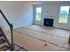 Spacious living room features fireplace and plenty of natural light from the large windows at 13308 Chopin Ridge Rd, Huntersville, NC 28078
