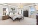 Large main bedroom with ample natural light, a chandelier, and neutral decor at 13308 Chopin Ridge Rd, Huntersville, NC 28078