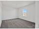 A bedroom features plush carpeting and a window with natural light at 13744 Roderick Dr # 173, Huntersville, NC 28078