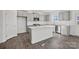 Bright kitchen with gray cabinets, white countertops, island, stainless steel appliances and wooden floors at 13744 Roderick Dr # 173, Huntersville, NC 28078