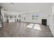Open floor plan with wooden floors, fireplace and natural light, connecting living room and kitchen at 13744 Roderick Dr # 173, Huntersville, NC 28078