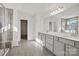 Elegant bathroom with double vanity, tiled floor, glass-enclosed shower, and walk-in closet at 13744 Roderick Dr # 173, Huntersville, NC 28078