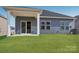 A spacious backyard with a covered patio and ample green space at 1418 Windy Park Dr, Stanley, NC 28164