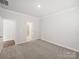 Spacious bedroom with carpet and white trim, showing an open doorway to a bathroom at 1418 Windy Park Dr, Stanley, NC 28164