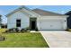 Charming single-story home with a manicured lawn and a two-car garage, providing both curb appeal and practicality at 1418 Windy Park Dr, Stanley, NC 28164