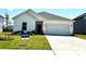 Charming single-story home featuring a well-manicured lawn and attached two-car garage at 1418 Windy Park Dr, Stanley, NC 28164