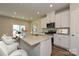 Spacious kitchen island with granite countertop and seating, perfect for meal preparation and dining at 1418 Windy Park Dr, Stanley, NC 28164