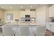 Modern kitchen island with light countertops and white cabinets, providing a central hub for cooking at 1418 Windy Park Dr, Stanley, NC 28164