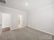 A spacious bedroom with neutral carpet and a view to an adjacent bathroom at 1422 Windy Park Dr, Stanley, NC 28164