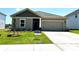 Charming one-story home with a manicured lawn, a two-car garage and neutral-colored siding at 1422 Windy Park Dr, Stanley, NC 28164