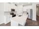 Modern kitchen with white cabinets, stainless steel appliances and a center island at 1422 Windy Park Dr, Stanley, NC 28164