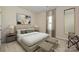Main bedroom featuring neutral tones, a large bed, and decorative accents at 1422 Windy Park Dr, Stanley, NC 28164