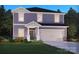 Charming two-story home with a two-car garage, landscaped front yard, and welcoming entrance at 1424 Windy Park Dr, Stanley, NC 28164