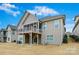 Exterior view of the home's back yard featuring a covered deck and lower patio at 14629 Glen Valley Ct, Charlotte, NC 28278