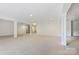 Expansive finished basement with neutral carpet, recessed lighting and support columns at 14629 Glen Valley Ct, Charlotte, NC 28278