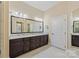 Bathroom showcasing double sinks with granite counters and vanity with a large framed mirror at 14629 Glen Valley Ct, Charlotte, NC 28278