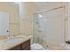 Bathroom showcasing a glass shower, granite countertop, with dark cabinets and tile floors at 14629 Glen Valley Ct, Charlotte, NC 28278