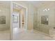Modern bathroom featuring a glass-enclosed shower with neutral tile and a walk-in closet at 14629 Glen Valley Ct, Charlotte, NC 28278