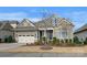 Charming home featuring stone accents, neutral siding, a well-maintained lawn, and an attached two-car garage at 14629 Glen Valley Ct, Charlotte, NC 28278