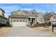 Charming home featuring stone accents, neutral siding, a well-maintained lawn, and an attached two-car garage at 14629 Glen Valley Ct, Charlotte, NC 28278