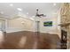 Bright living room featuring hardwood floors, a stone fireplace, and ample natural light from a skylight at 14629 Glen Valley Ct, Charlotte, NC 28278