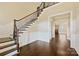 A staircase featuring hardwood floors, and decorative molding adds charm to this open-concept living space at 14629 Glen Valley Ct, Charlotte, NC 28278