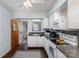 Functional kitchen featuring white cabinetry, updated appliances, and hardwood floors for a modern touch at 15905 Sunset Dr, Huntersville, NC 28078