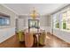 Bright dining room featuring designer wallpaper, modern chandelier, and seating for six people at 1816 Beverly Dr, Charlotte, NC 28207