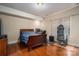 Bedroom with hardwood floors, neutral walls, a bed, a desk, and a birdcage by the window at 1974 Glen Manor Ct, Lincolnton, NC 28092