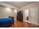 Cozy bedroom with hardwood floors, ensuite bathroom, and television on dresser at 1974 Glen Manor Ct, Lincolnton, NC 28092