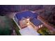 Stunning aerial view of a two-story brick home with an attached garage and a paved driveway at 2302 Rayecliff Ln, Charlotte, NC 28214