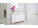 Bathroom featuring a modern vanity, glass-enclosed shower, and bright accent flower arrangement at 2302 Rayecliff Ln, Charlotte, NC 28214