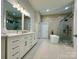 Bright bathroom features a double vanity, soaking tub, and glass enclosed shower at 2302 Rayecliff Ln, Charlotte, NC 28214