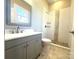 Bathroom with modern vanity, stylish tiled shower and neutral color scheme at 2302 Rayecliff Ln, Charlotte, NC 28214