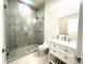 Bathroom showcasing marble-look tiled shower and white vanity with chrome fixtures at 2302 Rayecliff Ln, Charlotte, NC 28214