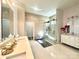 Modern bathroom with a double vanity, glass-enclosed shower, and decorative accents offers a luxurious experience at 2302 Rayecliff Ln, Charlotte, NC 28214