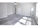 Spacious bedroom with gray wood-look floors, walk-in closet, and ensuite bathroom access; bright and open at 2302 Rayecliff Ln, Charlotte, NC 28214