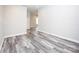 View of a bedroom with gray-toned wood flooring and neutral colored walls at 2302 Rayecliff Ln, Charlotte, NC 28214