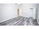 Spacious bedroom with gray wood-look floors and ensuite bathroom access; lots of natural light at 2302 Rayecliff Ln, Charlotte, NC 28214